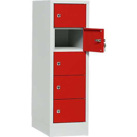 A white and red cabinet with multiple compartments, one compartment is open, two keys are inserted.
