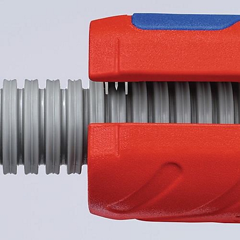 Close-up of tool: A red and blue wrench gripping a gray, corrugated pipe.