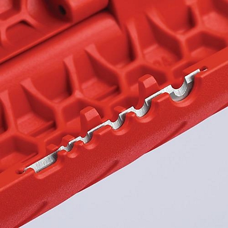 Close-up of a red tool with a silver cutting edge.