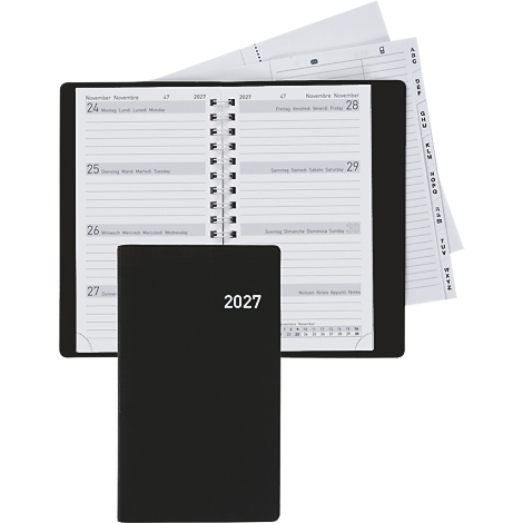 Schwarzes Notizbuch mit der Jahreszahl 2027 vor einem aufgeschlagenen Planer. Im Hintergrund sind Registerkarten zu sehen.