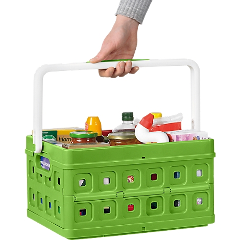 Green collapsible basket with groceries, held by a white handle.