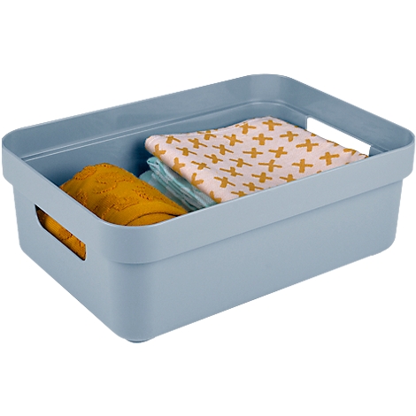 Light blue storage box filled with yellow and blue textiles. A textured yellow cloth and a cross patterned fabric.