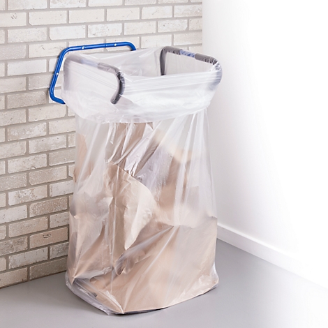 Sac poubelle avec déchets, dans un support sur un mur en briques. Cadre noir, support bleu.