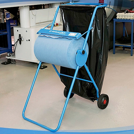 Chariot de nettoyage bleu avec rouleau de papier, à côté d'un sac noir. Impression : Kimberly-Clark.
