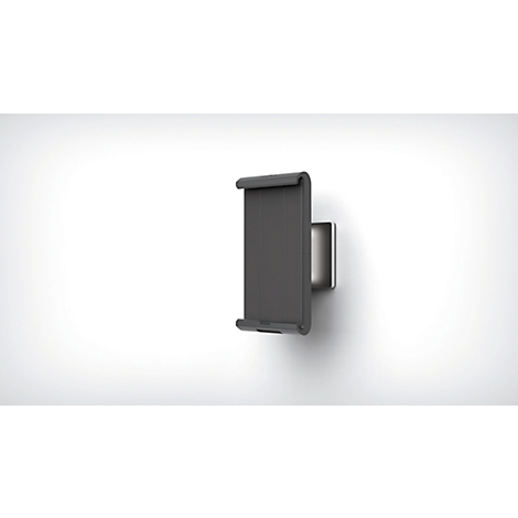 A gray tablet holder mounted on a white wall. The tablet is held by two arms on the holder.