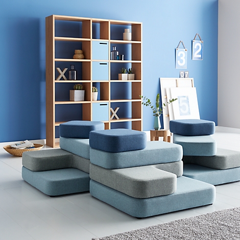 Modular sofas in different blue and grey tones in a stylish living room.