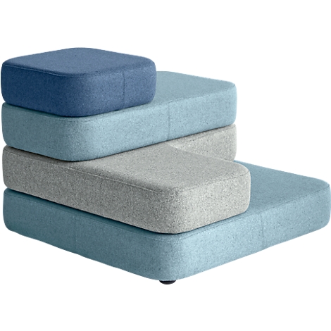 Stacked seat cushions in blue and gray tones. The cushions are square and rectangular, forming an abstract shape.