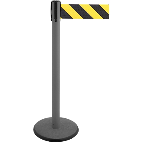 Gray bollard with black and yellow striped barrier tape. The bollard has a round base and a black top.