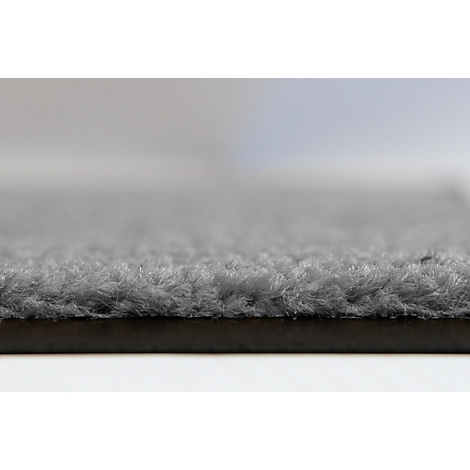 Gros plan d'une surface textile grise et duveteuse avec une texture douce et irrégulière.