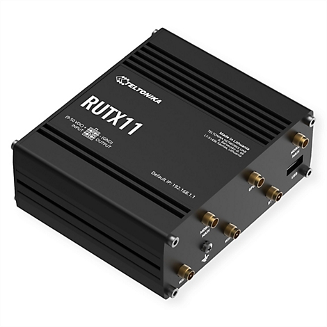 Vue de dessus d'un routeur RUTX11 noir. Montre les ports pour les antennes et l'entrée d'alimentation.