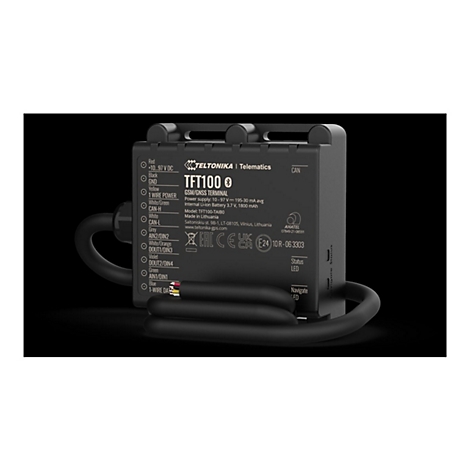 Schwarzes elektronisches Gerät mit Beschriftungen und Kabeln. Aufschrift: TFT100 GSM/GNSS Terminal.