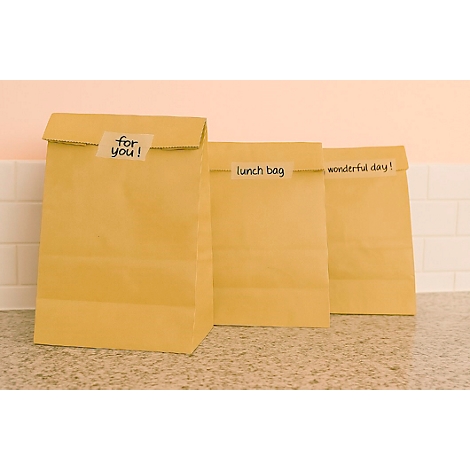 Three brown paper bags with the texts: "for you!", "lunch bag" and "wonderful day!". They stand on a kitchen counter.