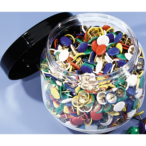 A clear jar full of colorful push pins, with an open black lid.