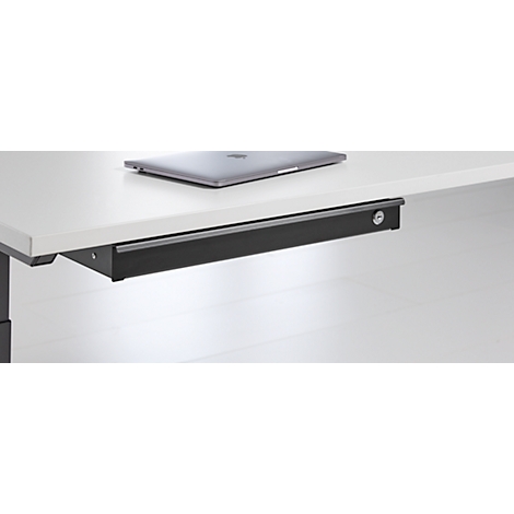 Gros plan d'un système de tiroir noir sous la table avec un trou de serrure.