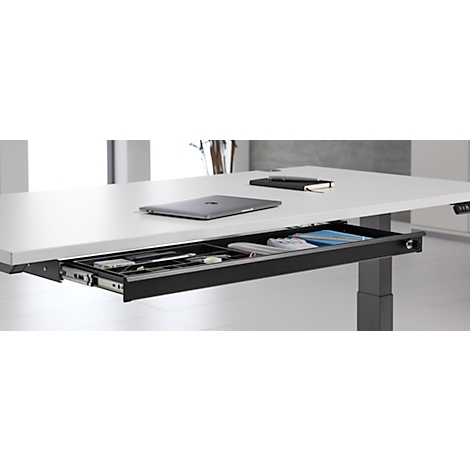 Bureau avec tiroir intégré, ordinateur portable, bloc-notes et stylo. Le tiroir contient des fournitures de bureau. Pieds de bureau gris.