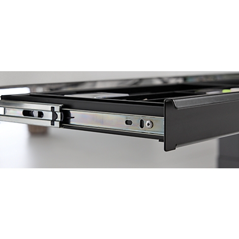 Gros plan sur un tiroir noir tiré d'un meuble, en se concentrant sur les rails métalliques.