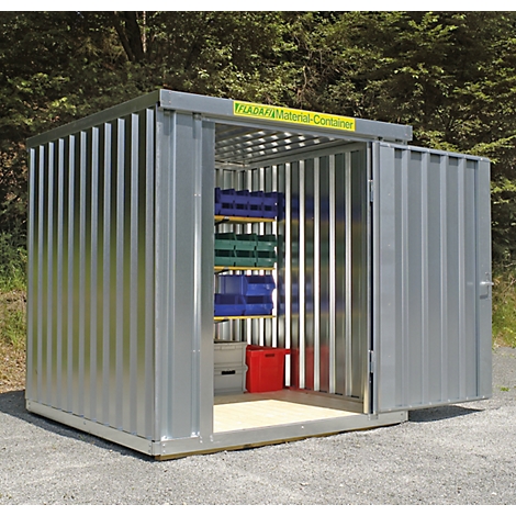 Grey metal container construction, open door. Inside shelves with blue and green boxes. Yellow lettering on the roof.