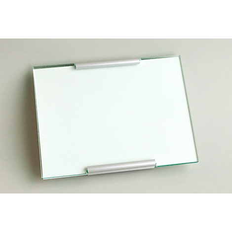 A rectangular glass plate with silver holders. The plate is placed slightly diagonally on a gray background.