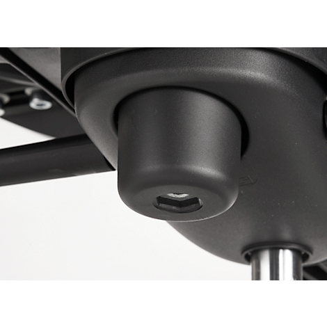 Close-up of a black chair part. A hexagonal insert is clearly visible.