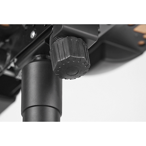 Close-up of the black adjustment knob of an office chair. The knob is ribbed for better grip. Behind it, part of the chair base.