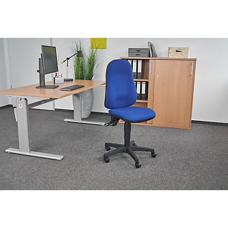 Office chair with a blue seat. To the right of it is a desk with a computer and cabinet.