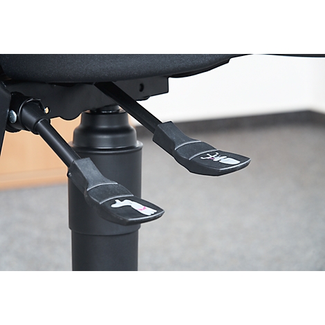 Close-up of the controls of an office chair. Two levers with pictograms.