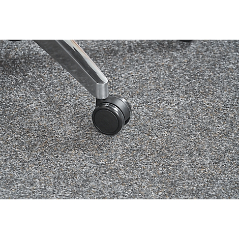 Close-up of chair leg with wheel on gray carpeted floor.
