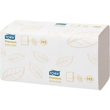 A package of Tork Premium Extra Soft H3 paper towels, white with brown leaves. Text: Tork Premium Extra Soft.