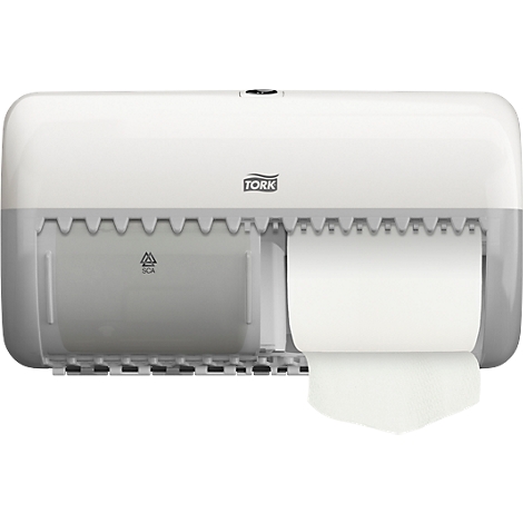 A white Tork towel dispenser, paper is being pulled from the dispenser.