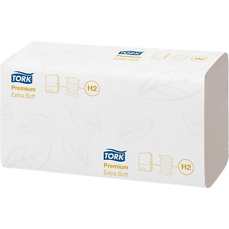 White Tork paper towel pack with logo and "Premium Extra Soft" text.