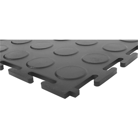 Close-up of a black interlocking rubber floor tile with raised circles.
