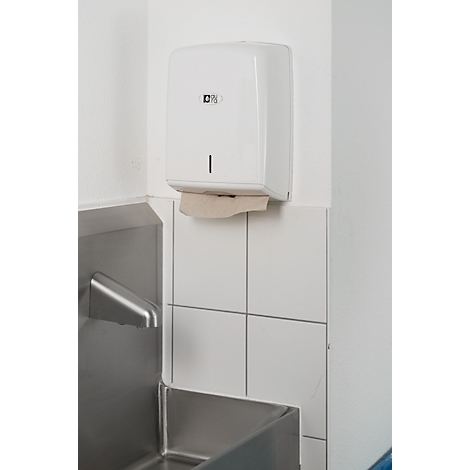 White paper towel dispenser on white wall, above a stainless steel sink. A paper towel is hanging out.
