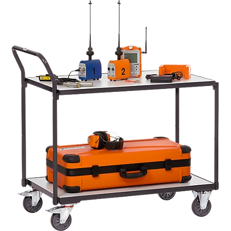 Equipment cart with measuring instruments. Measuring devices on the upper shelf, a suitcase and hearing protection on the lower one.