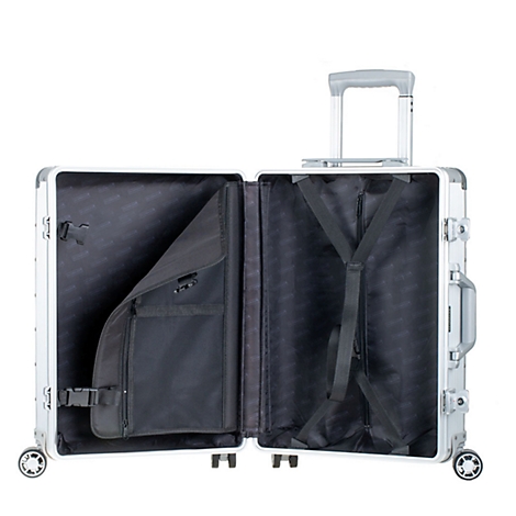 Valise argentée ouverte avec doublure noire. Une poche à gauche, des sangles à droite. La poignée est déployée.