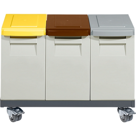 Three bins with yellow, brown, and gray lids stand on a trolley.