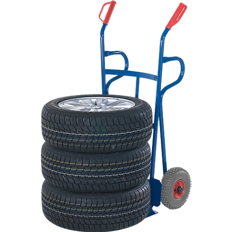 Blue hand truck carrying three tires and a wheel with rim.
