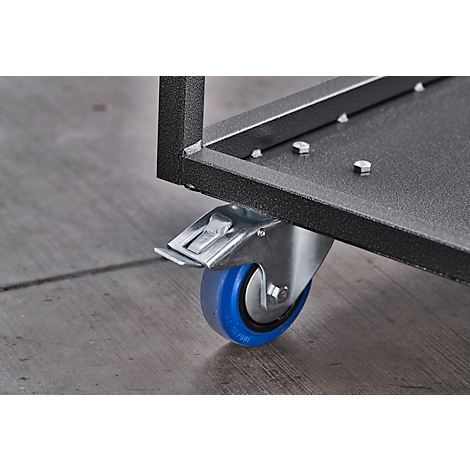 Close-up of a black metal frame with a wheel with a blue tread attached. The floor is grey.