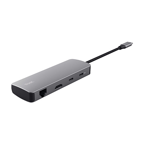Ein grauer USB-C-Hub der Marke Trust mit mehreren Anschlüssen und kurzem Kabel vor weißem Hintergrund.