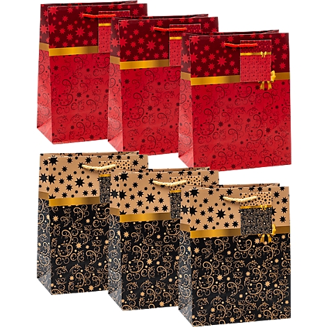 Drie rode en drie beige en zwarte cadeauzakjes met sterren- en krulpatronen en een gouden horizontale streep.