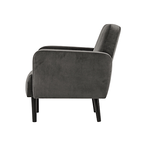 Grijze fauteuil in profiel, met donkere poten, fluwelen stof.