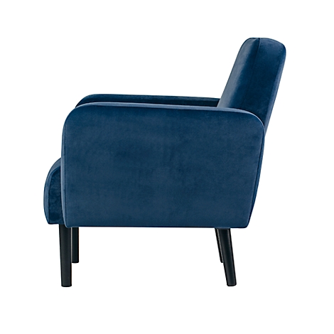 Blauwe fauteuil in profiel. Fluweelstof, zwarte poten.
