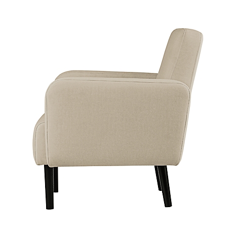 Beige fauteuil, zijaanzicht. Zwarte poten, rechte lijnen.