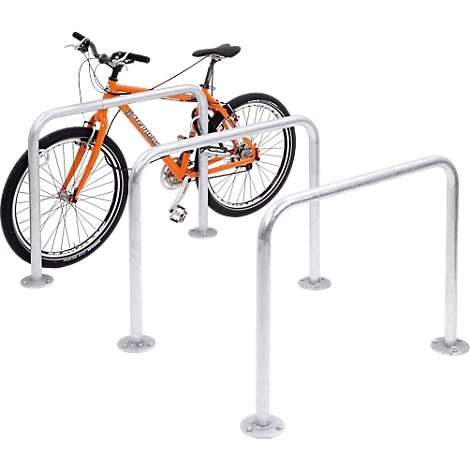 An orange bicycle in a silver bike rack. The rack is U-shaped.