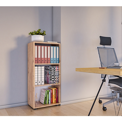 A bright shelf with folders, files, magazines, and books. Next to it a desk with a chair.