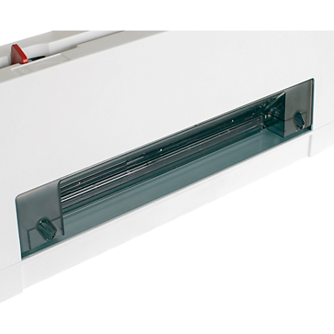 Close-up of a white machine featuring a transparent, elongated window. The machine has a red button and screws.