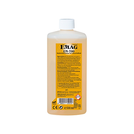 Bottle of EMAG EM-700 cleaner, light brown liquid, white cap, yellow label with text.