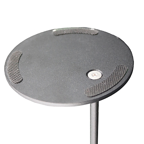 Close-up van een grijze ronde plaat met drie antislip pads en een zilveren bout.