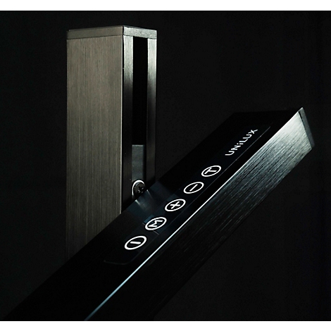 Metallic standing lamp with control panel, UNILUX lettering and controls. Dark background.