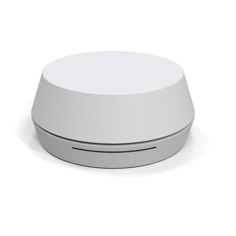 Grijs, rond slaapapparaat met knoppen. Een witte, koepelvormige behuizing bovenop, een grijs bedieningspaneel eronder.