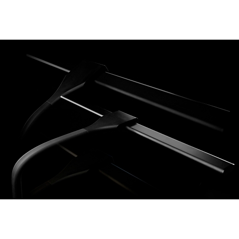 Close-up van twee zwarte kleerhangers op een zwarte achtergrond, lichte schaduwen.